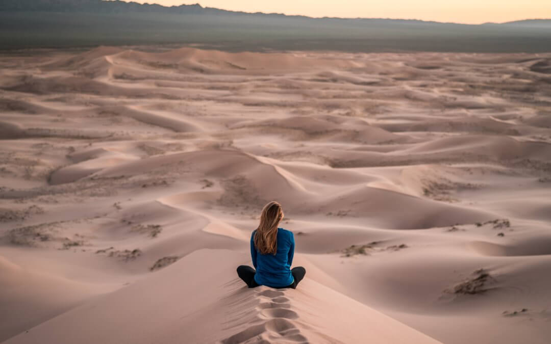 Woman Sitting in Dunes