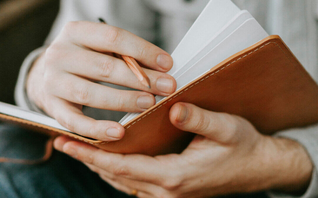 Man Writing in Journal