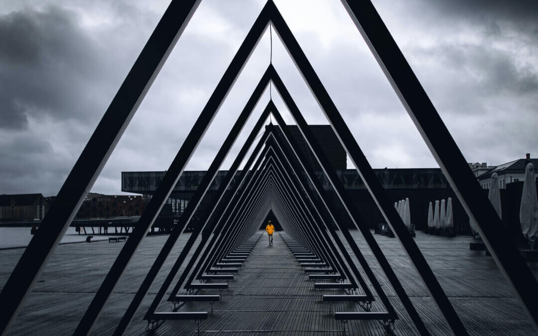man walks within triangles